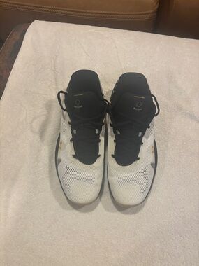 Under Armour Men's White and Black Athletic Shoes with Gold Accents